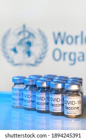 PENANG, MALAYSIA - 14 JAN 2021: Covid-19 Vaccine Vials With The World Health Organization (WHO) As Background. WHO Is An Agency Of The United Nations Responsible For International Public Health.