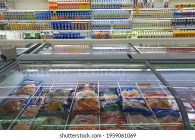 PENANG, MALAYSIA - 16 APR 2021: Interior view of huge glass fridge with various brand foods and beverage in Giant grocery store, Penang. Giant is a famous and trusted supermarket brand in Malaysia.