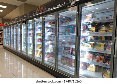 PENANG, MALAYSIA - 18 MAR 2021: Interior view of the huge fridge with various brand frozen food in Aeon retail store, Penang. AEON is the largest retailer in Asia, formerly known as JUSCO supermarket.