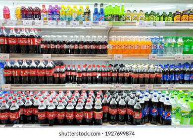 PENANG, MALAYSIA - 19 DEC 2021: View of various brand carbonated soft drink on the refrigerator shelf in Aeon grocery store. Aeon is the coolest fresh premium supermarket in Malaysia.