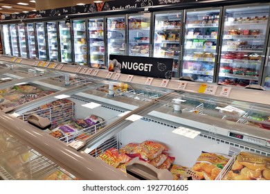 PENANG, MALAYSIA - 19 FEB 2021: Interior view of huge fridge with various brand frozen food in Aeon grocery, Penang. AEON is the largest retailer in Asia, formerly known as JUSCO supermarket.
