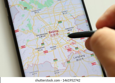 PENANG, MALAYSIA - 26 JULY 2019: Man Using A Google Maps Application Plan For  Holiday Around China On Android Phone. It Is A Most Popular Web Mapping Service For Mobile Provided By Google Inc.