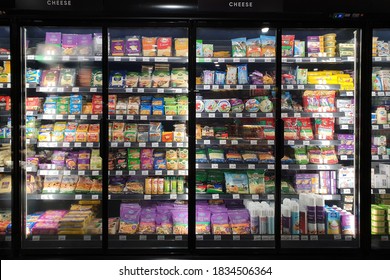 PENANG, MALAYSIA - 5 OCT 2020: Interior view of huge refrigerator shelves with various frozen food and dairy products and dairy products in a supermarket.