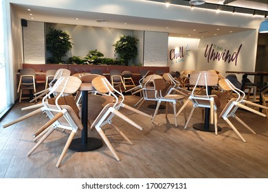 PENANG, MALAYSIA - 6 APR 2020: Interior View Of Closed Restaurant With Chairs Stapled On Tables During Pendemic Crisis In Penang.