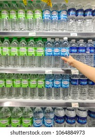 PENANG, MALAYSIA - April 05, 2018 - Rows of shelves with variety of drinking water & mineral water display in a Grocery Store in a mall.