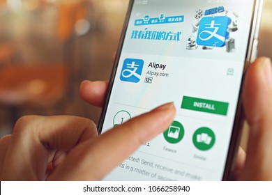 Penang, Malaysia - April 6, 2018: Woman holding smartphone with Alipay application on the screen. Alipay is a third-party mobile & online payment platform, established in Hangzhou, China in Feb 2004.