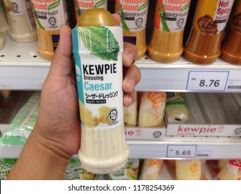 PENANG, MALAYSIA - AUGUST 27, 2018: Close Up Hand Holding A Bottle Of Kewpie Japan Recipe Caesar Dressing . Kewpie Is An Japanese Global Manufacturer Of Food Products.