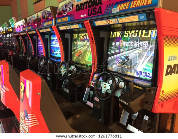 Penang, Malaysia - December 19, 2018 : View of a\
row of Daytona racing arcade machines inside an arcade shop at\
Gurney Plaza penang