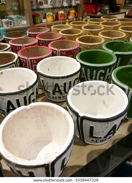 PENANG,\
MALAYSIA - December 20, 2017 - A variety of laugh word on colour\
car plate design mug, decoration gift item, are placed on shelves\
& display in the mall & gift\
store.