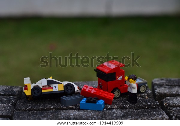 Penang,\
Malaysia - February 7, 2021: Lego man at road traffic accident\
scene that involved a sports car and a\
truck.