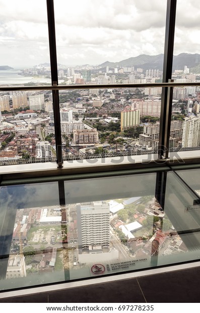 Penang, Malaysia - Jun 27, 2017: Observatory\
Deck with transparent glass floor at level 68 on roof top of Komtar\
Tower, Penang.\
Malaysia.