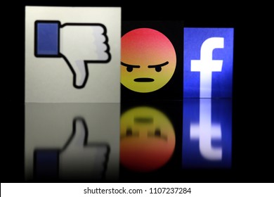 PENANG, MALAYSIA - JUNE 6, 2018: Facebook Security And Privacy Issues. Close Up Facebook Logo With The Dislike Icon And Angry Face Emoji Behind It On Black Background.