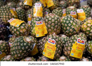 PENANG, MALAYSIA - Mar 09, 2019 - Dole Pineapple Display In The Supermarket. Dole Food Company, Inc. Is An American Agricultural Multinational Corporation Headquartered In Westlake Village, California