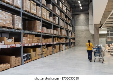 PENANG, MALAYSIA - MAY 11, 2020: Ikea Batu Kawan Warehouse Rack With Ikea Staff With Trolley 