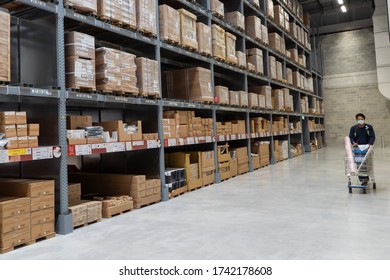 PENANG, MALAYSIA - MAY 11, 2020: Ikea Batu Kawan Warehouse Rack With Ikea Staff With Trolley 