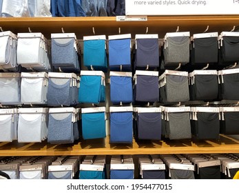 PENANG, MALAYSIA - NOV 16, 2020: Various Colour Of The Colourful Signature Uniqlo T-Shirt At Uniqlo Queensbay Mall Penang.