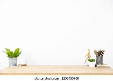 Pencil, Book, Model, Tree And Some Office Stuff And Decoration On The Clean And Clear Wooden Table. White Background And More Copy Space. Business Or Work Space Theme