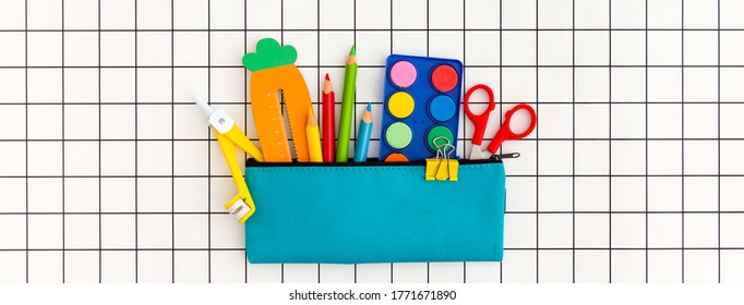 Pencil case with school supplies on grid background. Back to school concept banner. - Powered by Shutterstock