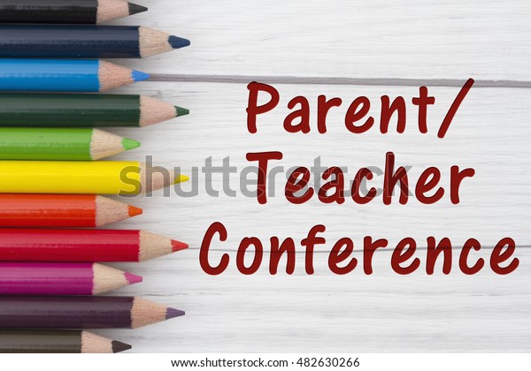 Pencil Crayons with text Parent-Teacher\
Conference with weathered wood\
background