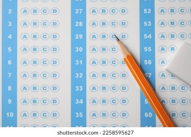 Pencil and eraser on answer sheet, flat lay. Student passing exam - Shutterstock ID 2258595627