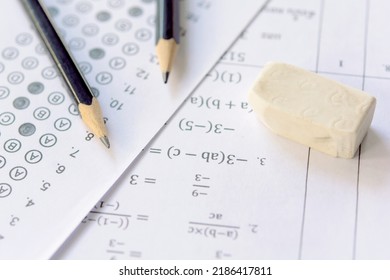 Pencil And Eraser On Answer Sheets Or Standardized Test Form With Answers Bubbled. Multiple Choice Answer Sheet