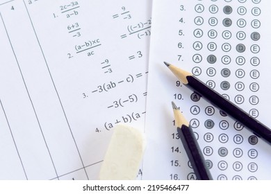 Pencil And Eraser On Answer Sheets Or Standardized Test Form With Answers Bubbled. Multiple Choice Answer Sheet