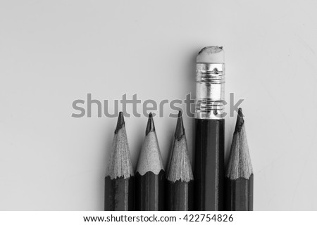 pencil eraser standing out from the row of pencils.