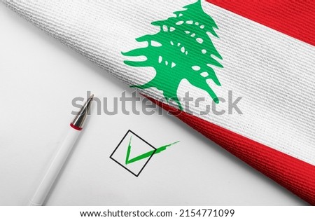 Pencil, Flag of Lebanon and check mark on paper sheet 