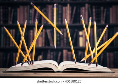 Pencil Floating On The Heavy Books