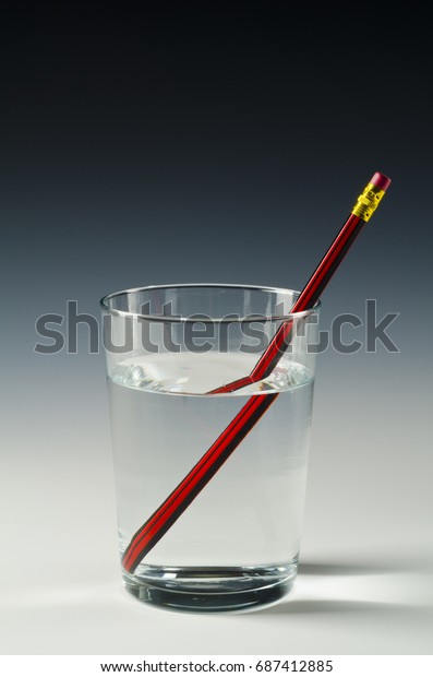 A
pencil in a glass of water shows light refraction.
