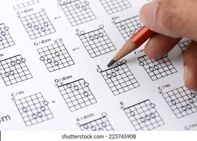 Pencil In Hand On Paper Of Chord Chart