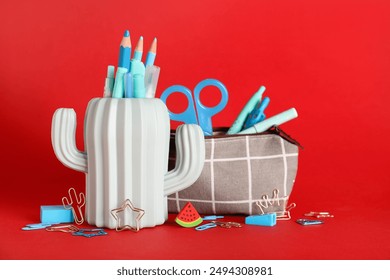 Pencil holder and pencil case with stationery on red background - Powered by Shutterstock