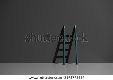 pencil leaned on the wall and creating ladder made of shadow