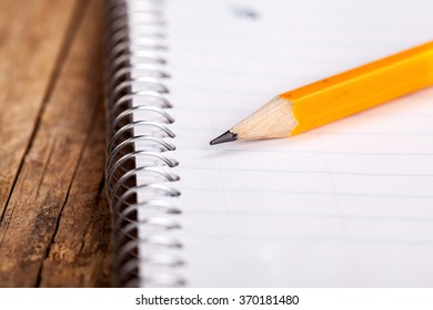 Pencil and a notebook up close