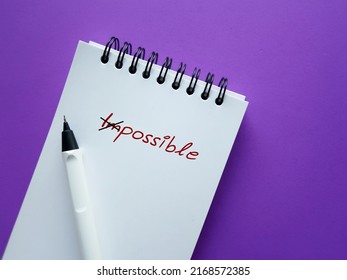 Pencil Notebook On Purple Background With Text Written IMPOSSIBLE Crossed Off To POSSIBLE, Keeping In Mind To Make The Impossible Possible, Focus On All The Ways To Accomplish Your Goals Accomplish