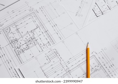 pencil and office tools for writing on the blueprint of construction industry. Place the rolls on a desk over blurred blueprint for construction industry background. construction industry concept. - Powered by Shutterstock