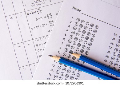 Pencil On Answer Sheets Or Standardized Test Form With Answers Bubbled. Multiple Choice Answer Sheet