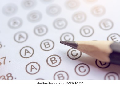 Pencil On Answer Sheets Or Standardized Test Form With Answers Bubbled. Multiple Choice Answer Sheet