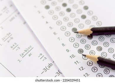 Pencil On Answer Sheets Or Standardized Test Form With Answers Bubbled. Multiple Choice Answer Sheet