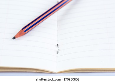 pencil on opened lined notebook close up