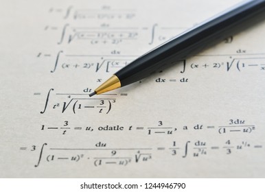 Pencil over a math book and advanced example with integrals - Powered by Shutterstock