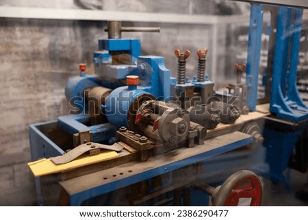 A pencil packaging machine on display at a museum.
