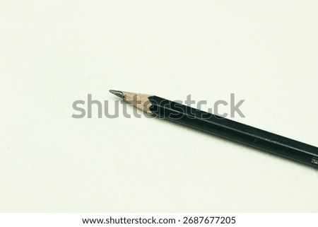 A pencil with a sharp tip after being sharpened on a white background.