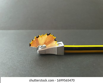 Pencil Sharpener Starting To Sharpen. Concept Of Starting, Beginning, Undertaking, Working, Forcing, Journey. Background Image For Business, Learning, Creative, Brainstorming.  Side View.