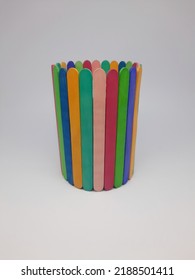 Pencil Stand Holder Made Of Colorful Ice Cream Sticks. School Craft Supplies And Materials, Children's Educational Facilities From Recycled Ice Cream Sticks. Selective Focus On A White Background.