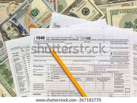 Pencil with tax form on US dollarbills background