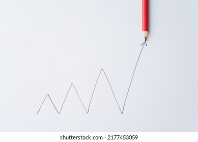 Pencil Write Chart Graph Swing Growing With Arrow Trend Rise Up On White Paper Background. Career Opportunity, Develop Performance, Improvement For Success Goal In Business Or Education Concept.