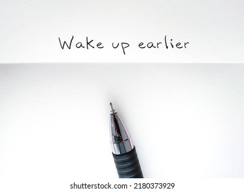 Pencil Writing A Goal On White Paper With Handwritten Text Wake Up Earlier, To Improve Overall Wellness, Enhances Productivity,decrease Stress Level From Being Rush To Work