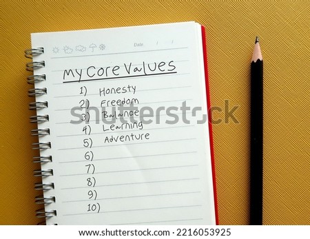 Pencil writing on notebook the list of MY CORE VALUES, to find or identify set of fundamental beliefs, ideals or practices which is direction of how to conduct life or career
