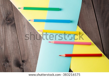 pencilees with crosser color band on rustic wooden table